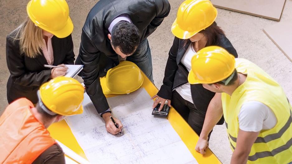 Gold Seal Certified professionals reviewing blueprints for a major construction project.